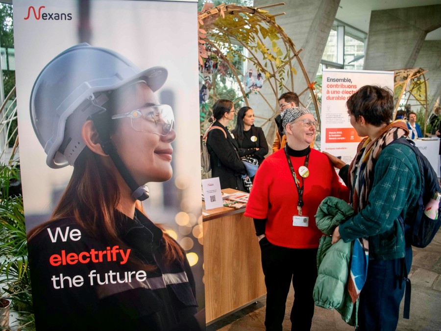 Women speaking at the Nexans' stand during the Université de la Terre 2025